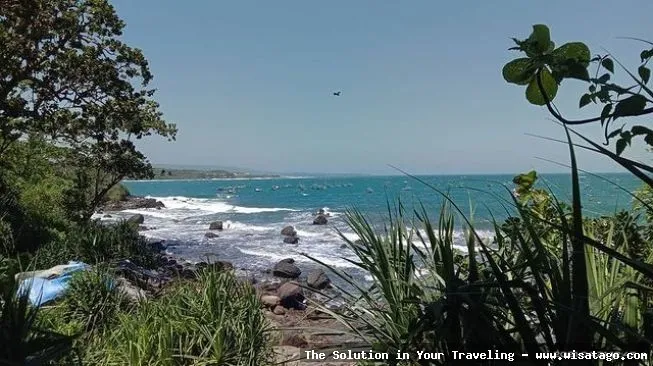 Pantai Jayanti dengan ombak biru.
